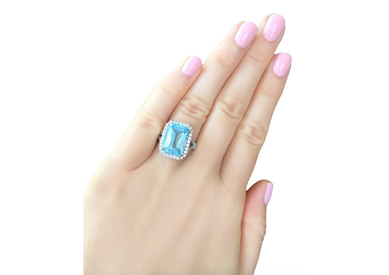 Sterling Silver 8 Carat Blue Topaz Emerald Cut Ring with 18 KGP Prongs by Bling